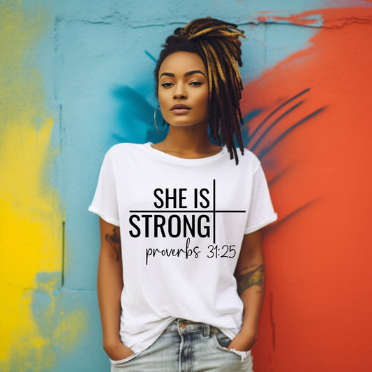 young women on wall wearing she is strong tee in white
